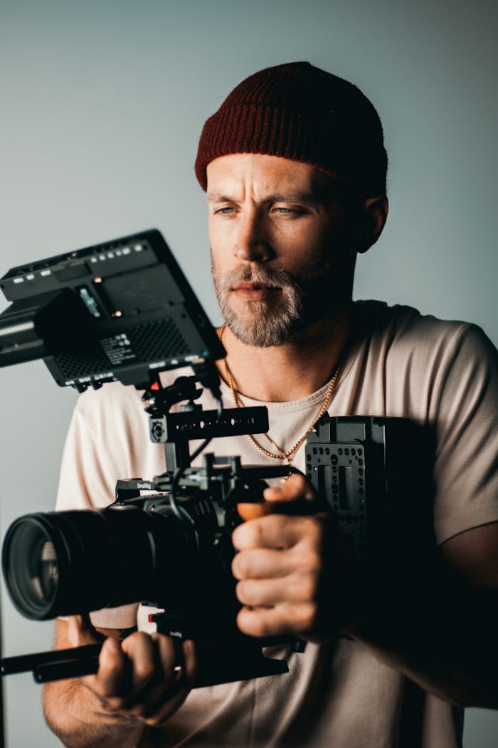Man holding high-end camera gear, capturing creative footage.